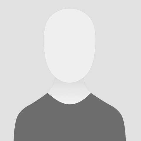 A simple, grayscale portrait of a person wearing a gray shirt with no visible facial features.