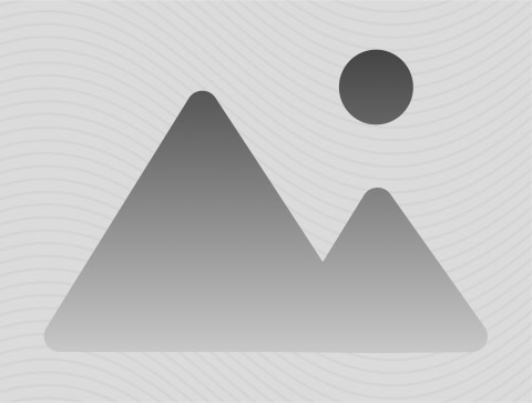 A grayscale image of a mountain landscape with a sun in the sky.